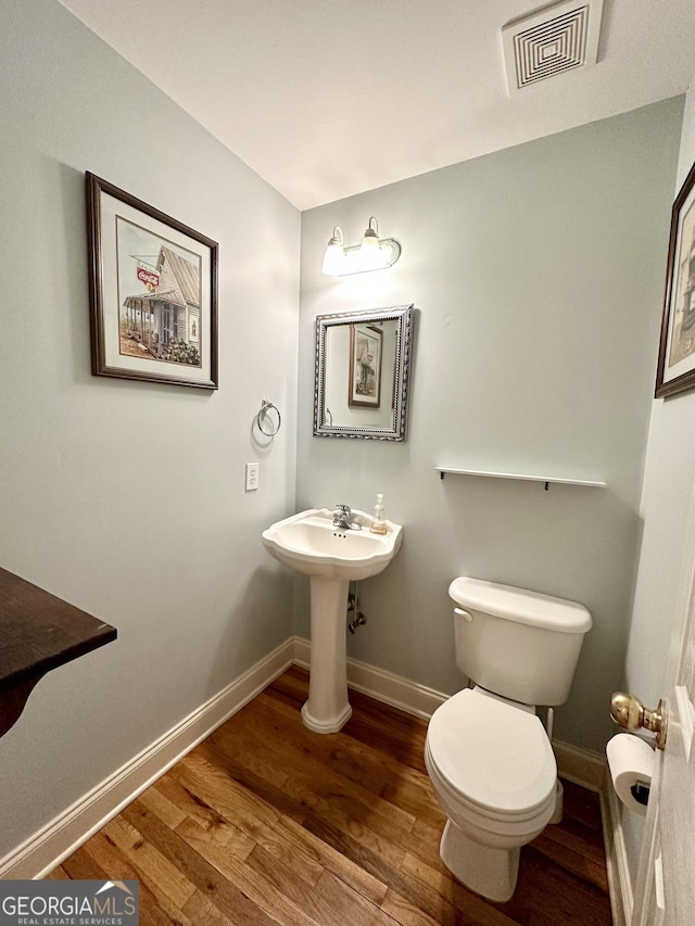 119 E Surry Ct, Athens, GA 30606 - bathroom with wood finished floors, toilet, and baseboards