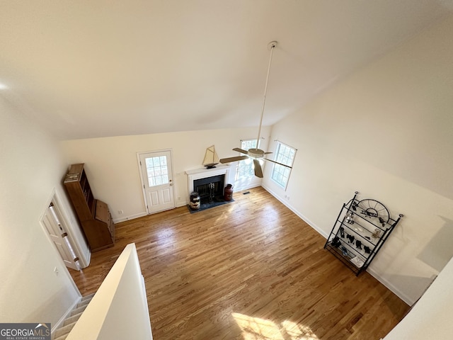 119 E Surry Ct, Athens, GA 30606 - unfurnished living room with ceiling fan, wood finished floors, baseboards, a fireplace with flush hearth, and high vaulted ceiling