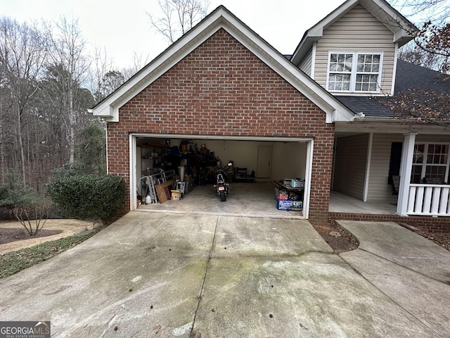 119 E Surry Ct, Athens, GA 30606 - view of property exterior with brick siding, driveway, a garage, covered porch, and roof with shingles