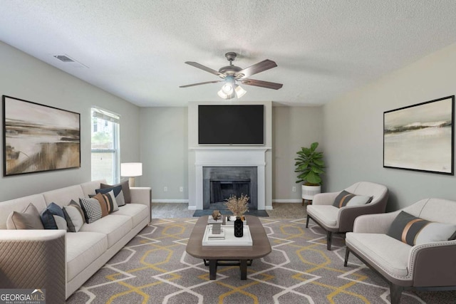 7250 Old Chapel, Atlanta, GA 30349 - living room with a ceiling fan, a textured ceiling, a fireplace with flush hearth, and carpet floors