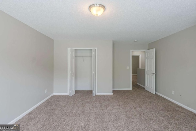 7250 Old Chapel, Atlanta, GA 30349 - unfurnished bedroom featuring carpet floors, a closet, and a textured ceiling