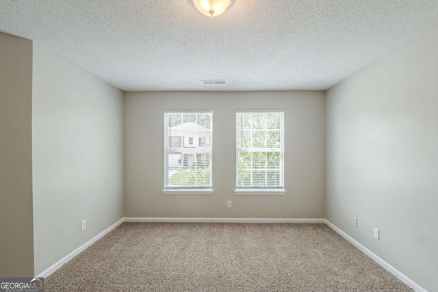 7250 Old Chapel, Atlanta, GA 30349 - empty room featuring carpet and a textured ceiling