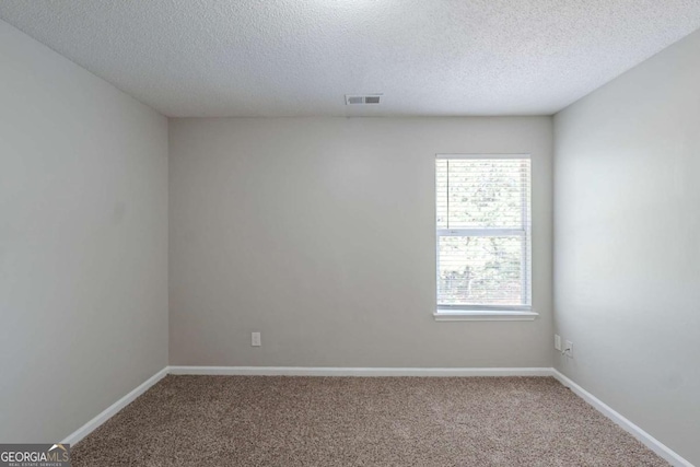 7250 Old Chapel, Atlanta, GA 30349 - empty room with healthy amount of natural light, carpet, and a textured ceiling