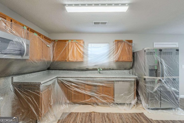7250 Old Chapel, Atlanta, GA 30349 - miscellaneous room with a textured ceiling and wood finished floors
