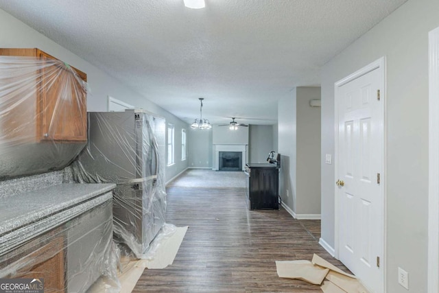 7250 Old Chapel, Atlanta, GA 30349 - hall with a textured ceiling, wood finished floors, and a chandelier