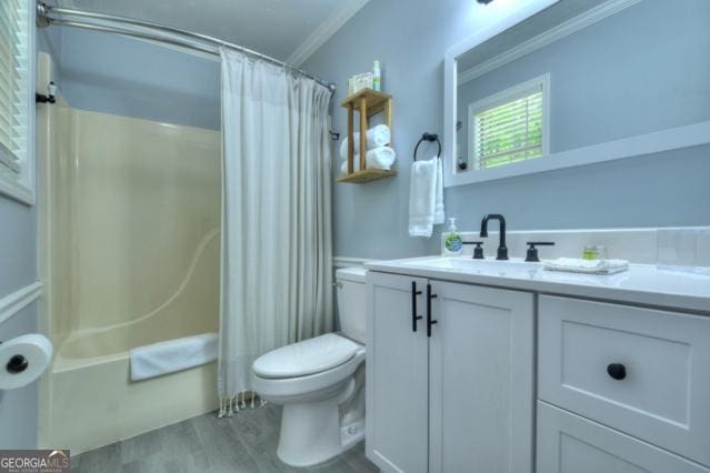 151 Padget Ln, Ellijay, GA 30540 - bathroom with vanity, toilet, ornamental molding, wood finished floors, and shower / bath combination with curtain