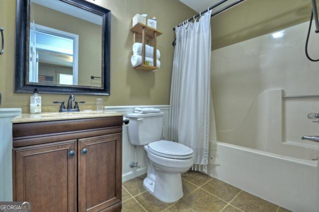 151 Padget Ln, Ellijay, GA 30540 - bathroom with toilet, vanity, shower / tub combo with curtain, tile patterned flooring, and a wainscoted wall