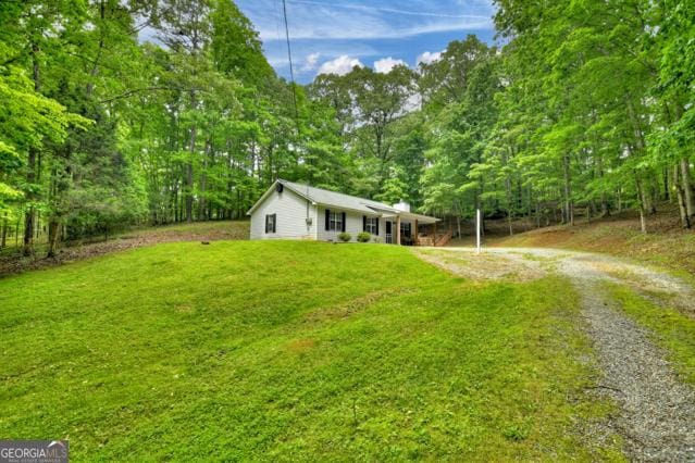 151 Padget Ln, Ellijay, GA 30540 - ranch-style house featuring dirt driveway, a front yard, and a wooded view