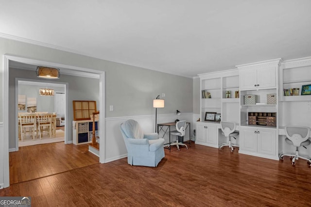 1504 Danora Dr, Waycross, GA 31501 - sitting room with wood finished floors, built in study area, a chandelier, and built in shelves