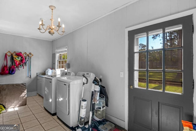 1504 Danora Dr, Waycross, GA 31501 - laundry area with independent washer and dryer, cabinet space, a chandelier, light tile patterned floors, and crown molding