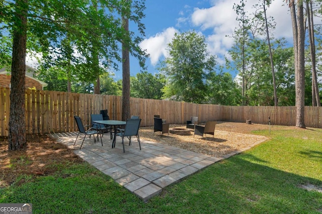 1504 Danora Dr, Waycross, GA 31501 - fenced backyard featuring an outdoor fire pit and a patio