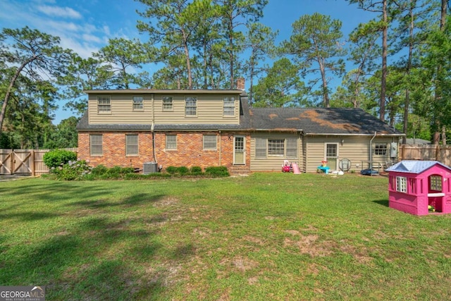 1504 Danora Dr, Waycross, GA 31501 - back of property with a fenced backyard, a chimney, and brick siding