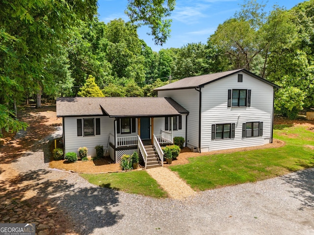 3142 Chamblee Gap Rd, Cumming, GA 30040 - tri-level home with covered porch, driveway, roof with shingles, and a front yard
