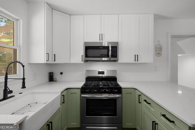 3142 Chamblee Gap Rd, Cumming, GA 30040 - kitchen with stainless steel appliances, green cabinetry, and white cabinets