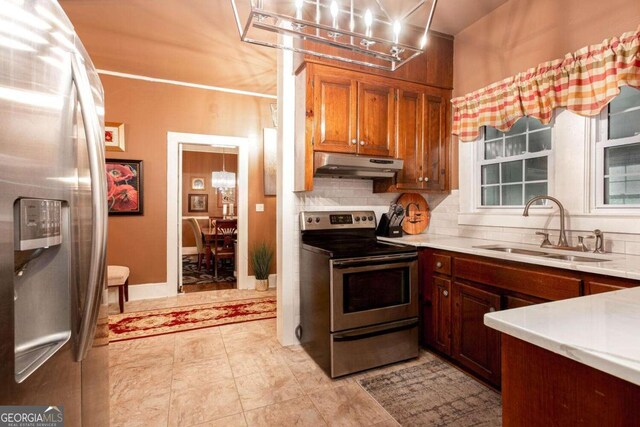 791 E Main St, Canton, GA 30114 - kitchen with stainless steel appliances, under cabinet range hood, light countertops, tasteful backsplash, and a chandelier