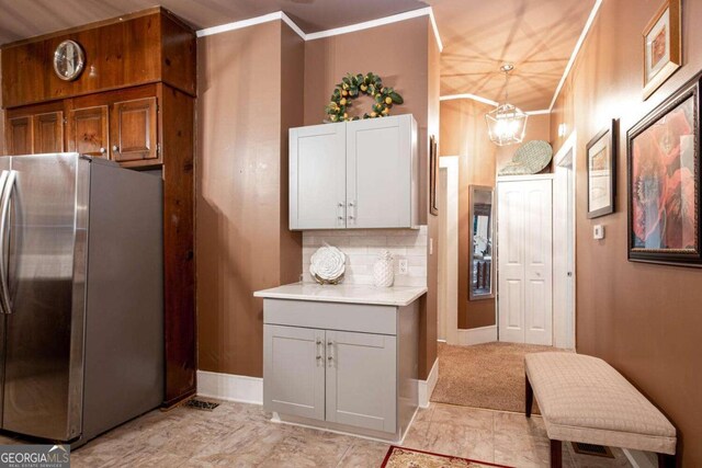 791 E Main St, Canton, GA 30114 - kitchen with freestanding refrigerator, ornamental molding, light countertops, and a chandelier