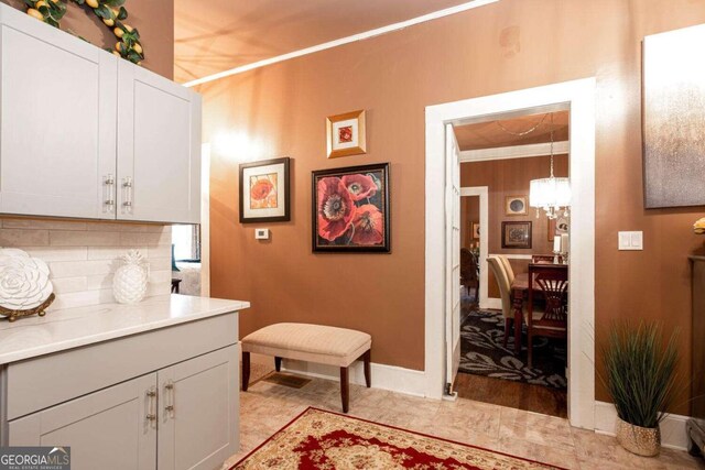 791 E Main St, Canton, GA 30114 - laundry room featuring a chandelier and crown molding