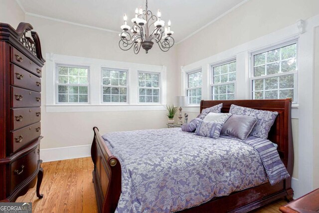 791 E Main St, Canton, GA 30114 - bedroom with a chandelier, light wood-type flooring, and crown molding