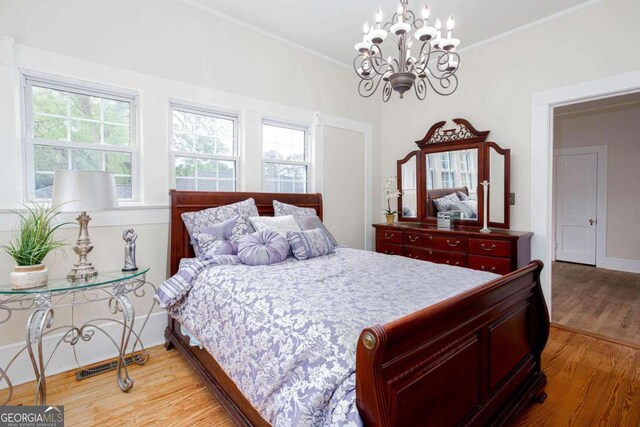 791 E Main St, Canton, GA 30114 - bedroom featuring light wood-type flooring, a chandelier, and ornamental molding