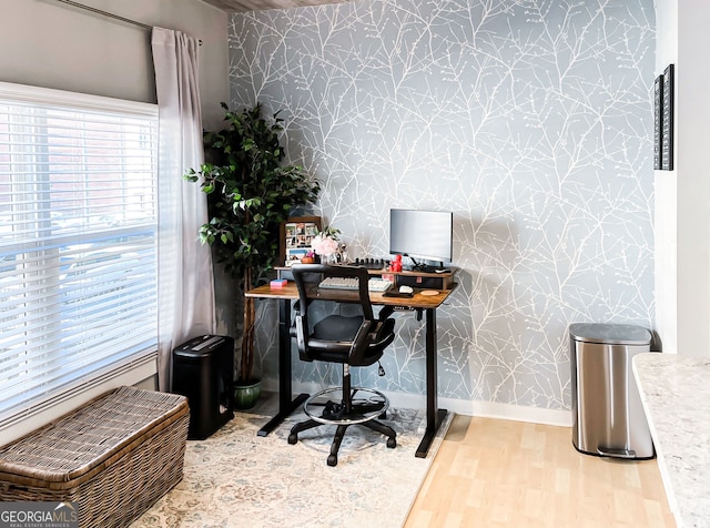800 Peachtree St NE Unit 1319, Atlanta, GA 30308 - home office featuring wallpapered walls, an accent wall, and wood finished floors