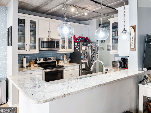 800 Peachtree St NE Unit 1319, Atlanta, GA 30308 - kitchen featuring stainless steel appliances, decorative backsplash, light stone counters, and glass insert cabinets