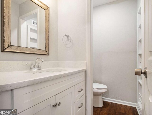 3149 Buford Hwy NE Unit 3, Brookhaven, GA 30329 - bathroom with vanity, toilet, wood finished floors, and baseboards