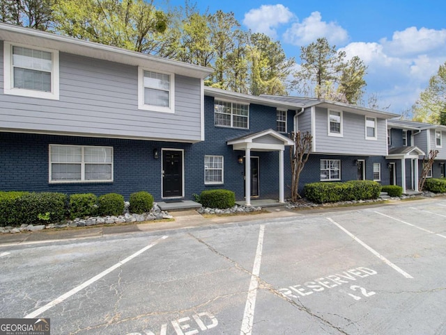 3149 Buford Hwy NE Unit 3, Brookhaven, GA 30329 - townhome / multi-family property featuring uncovered parking and brick siding