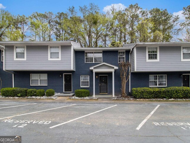 3149 Buford Hwy NE Unit 3, Brookhaven, GA 30329 - townhome / multi-family property with brick siding and uncovered parking