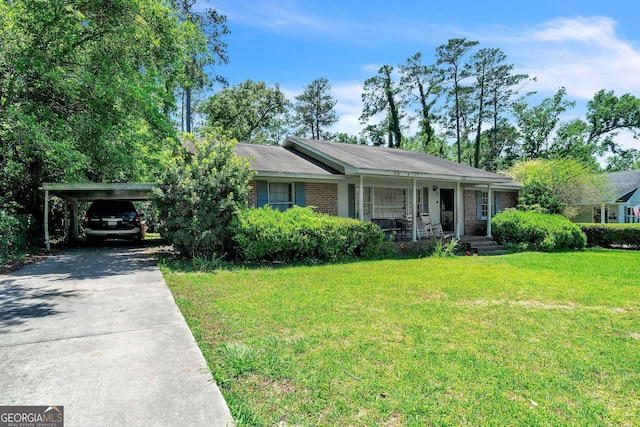 202 Pine St, Quitman, GA 31643 - view of front of property featuring concrete driveway, covered porch, a front yard, brick siding, and an attached carport