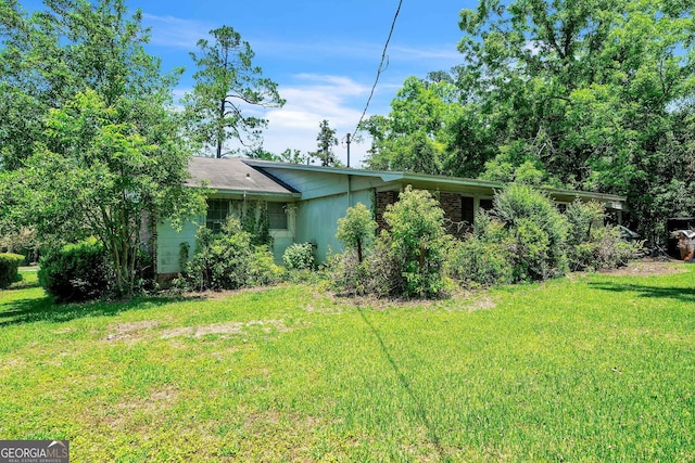 202 Pine St, Quitman, GA 31643 - view of side of property featuring a lawn