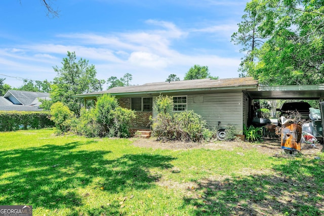 202 Pine St, Quitman, GA 31643 - rear view of property featuring a yard and an attached carport