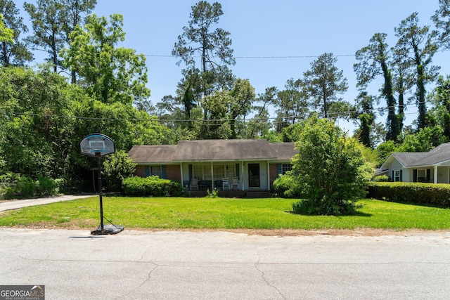 202 Pine St, Quitman, GA 31643 - ranch-style house with a front yard, covered porch, and brick siding