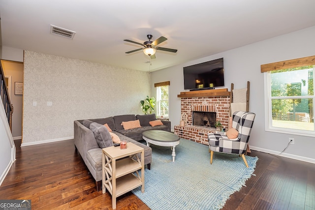 979 Rowe Rd, Senoia, GA 30276 - living area featuring wood-type flooring, a ceiling fan, baseboards, and a brick fireplace