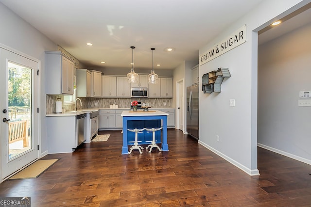 979 Rowe Rd, Senoia, GA 30276 - kitchen featuring stainless steel appliances, light countertops, a center island, dark wood-style flooring, and recessed lighting