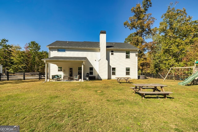 979 Rowe Rd, Senoia, GA 30276 - rear view of house with a patio area, a chimney, and a playground