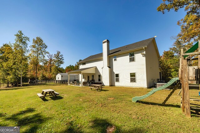 979 Rowe Rd, Senoia, GA 30276 - rear view of house featuring a playground and a chimney
