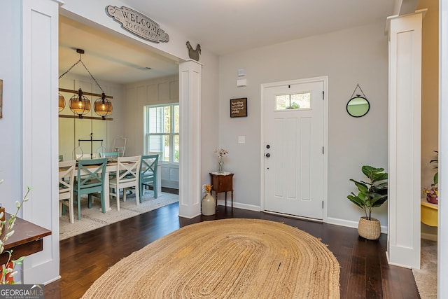 979 Rowe Rd, Senoia, GA 30276 - foyer with healthy amount of natural light, wood finished floors, ornate columns, and baseboards