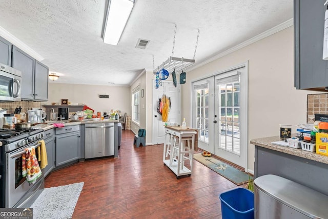 850 Long Branch Cir, Sugar Hill, GA 30518 - kitchen with stainless steel appliances, decorative backsplash, plenty of natural light, a textured ceiling, and french doors