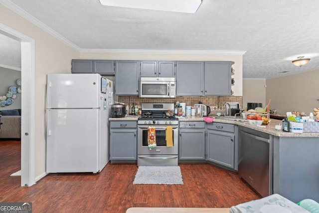 850 Long Branch Cir, Sugar Hill, GA 30518 - kitchen with appliances with stainless steel finishes, gray cabinets, dark wood finished floors, ornamental molding, and a textured ceiling