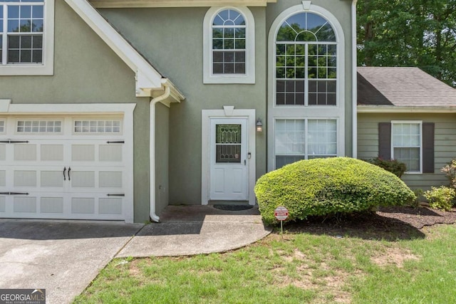 850 Long Branch Cir, Sugar Hill, GA 30518 - view of exterior entry with stucco siding and concrete driveway