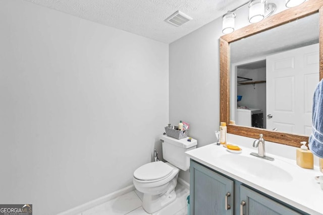 850 Long Branch Cir, Sugar Hill, GA 30518 - half bathroom with toilet, vanity, a textured ceiling, baseboards, and washer / clothes dryer
