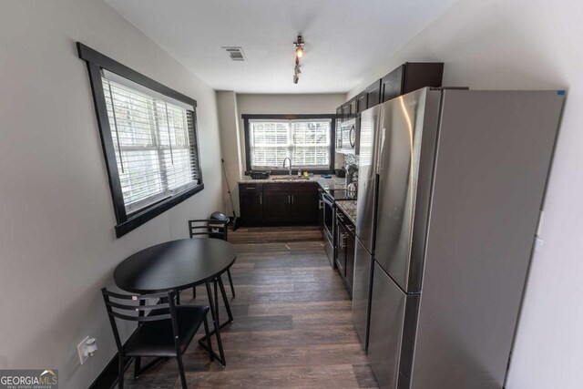 1764 Spring Ave, East Point, GA 30344 - kitchen with appliances with stainless steel finishes and dark wood-style flooring