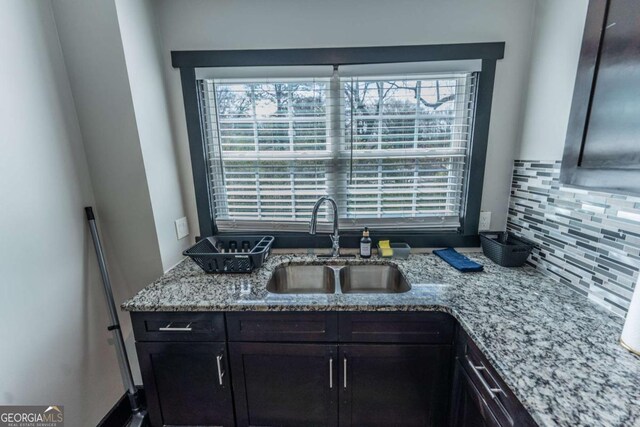 1764 Spring Ave, East Point, GA 30344 - kitchen featuring tasteful backsplash, light stone countertops, and plenty of natural light