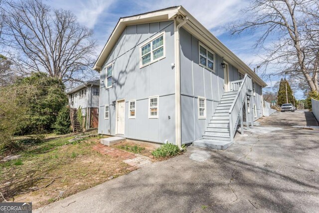 1764 Spring Ave, East Point, GA 30344 - view of property exterior with stairs and board and batten siding
