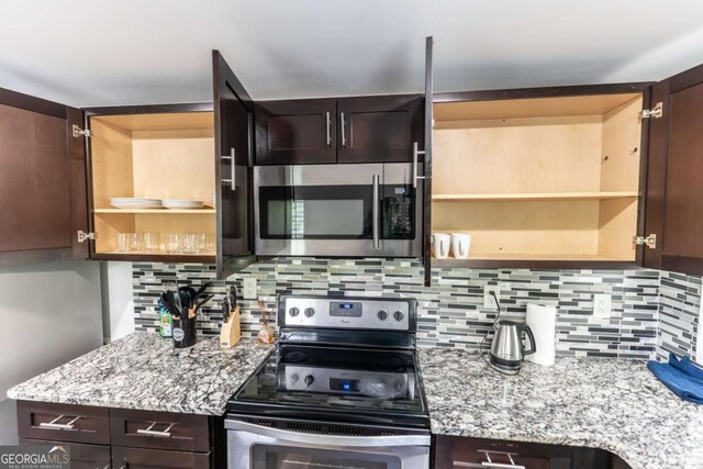 1764 Spring Ave, East Point, GA 30344 - kitchen with appliances with stainless steel finishes, open shelves, and dark brown cabinets
