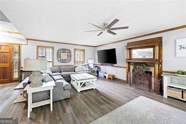 2041 Millspring Way NW, Kennesaw, GA 30152 - living room featuring a ceiling fan, wood finished floors, ornamental molding, a textured ceiling, and a fireplace