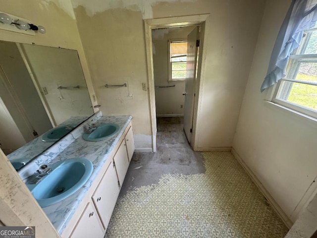 7782 Church St, Bartow, GA 30413 - bathroom with healthy amount of natural light, double vanity, and baseboards