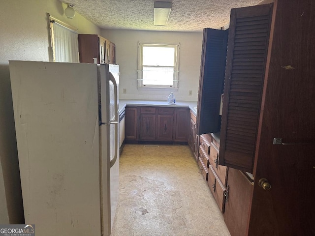 7782 Church St, Bartow, GA 30413 - kitchen featuring freestanding refrigerator, a textured ceiling, and light countertops