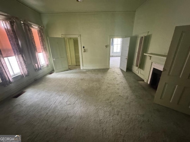 7782 Church St, Bartow, GA 30413 - unfurnished living room with healthy amount of natural light, carpet flooring, and a brick fireplace