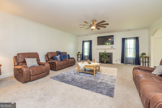 2689 Muskeg Ct SW, South Fulton, GA 30331 - living area with carpet flooring, a ceiling fan, ornamental molding, arched walkways, and a fireplace with flush hearth